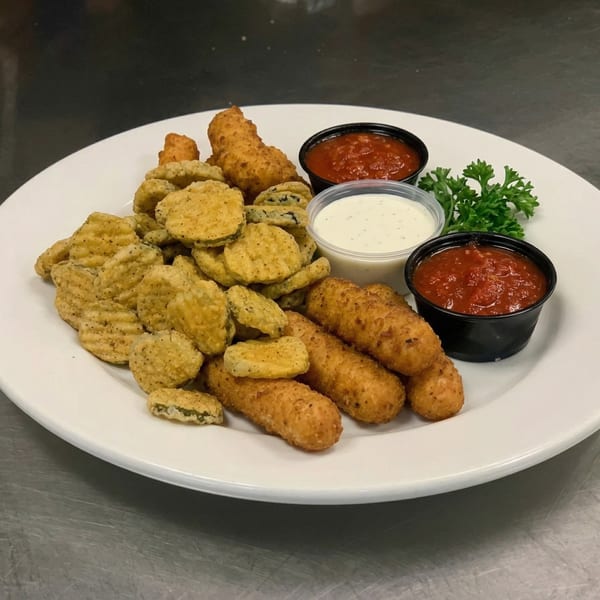A white plate holds fried pickles, mozzarella sticks, marinara sauce, and ranch dressing.